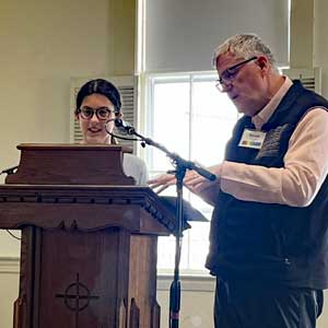 youth and pastor at lectern