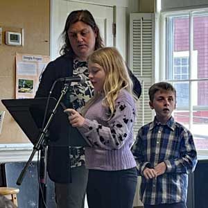Youth and parent at lectern