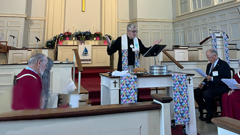 Rev. Derek at the Communion Table